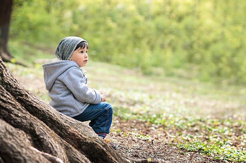 boy sitting in nature